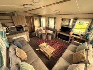 an aerial view of a living room in a rv at Fabulous Beach Getaway Naish Est near New Forest in New Milton