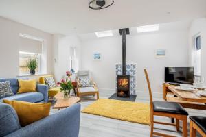 a living room with a couch and a fireplace at Charlotte Cottage in Poole