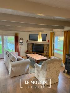 a living room with a couch and a table at Cottage Ouessant in Kerellec (watermill 5km Roscoff) in Plougoulm