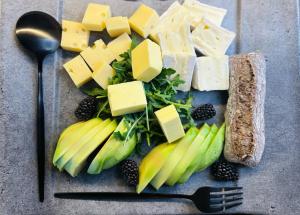 a plate of food with cheese and fruits and vegetables at Residence Pranterhof in Marlengo