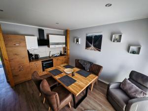 comedor con mesa y sillas y cocina en Ferienwohnung Vogt, en Blankenburg