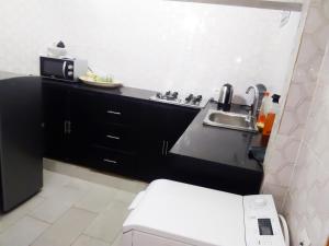 a small bathroom with a sink and a toilet at Keur Mina in Saint-Louis