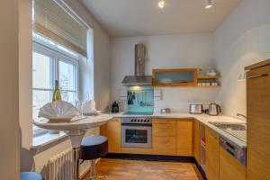 a kitchen with a sink and a stove top oven at VOLLMOBLIERT inkl. WiFi - 1-Zi-Wo in Munich