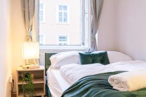 a bedroom with two beds and a window at Metropolitan Charm: Stylish 2+1 Apt@ Vienna's Core in Vienna