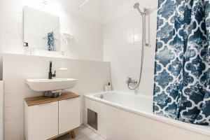 a bathroom with a sink and a tub and a shower at Metropolitan Charm: Stylish 2+1 Apt@ Vienna's Core in Vienna