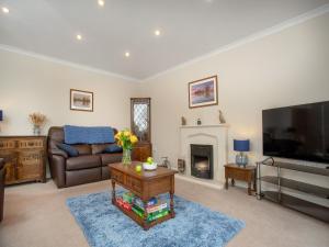 a living room with a couch and a television at The Sowy in Bridgwater