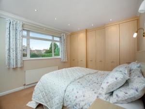 a bedroom with a bed and a window at The Sowy in Bridgwater