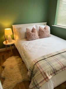 a bedroom with a bed with a rug on the floor at Cosy 2 Double Bed Apartment in Swords