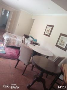 a living room with a table and a bed at 50 Arklow in Johannesburg