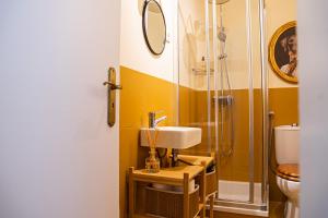 a bathroom with a sink and a shower at Impar Triplex House in Porto