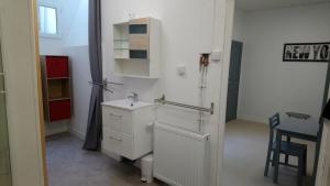 un pequeño baño blanco con lavabo y mesa en Studio N°2 Boston Conciergerie Leroy, en Boulogne-sur-Mer