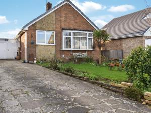 a brick house with a stone driveway in front of it at Shirleys Place in Boston Spa