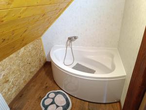 a bath tub in a corner of a bathroom at Holiday Home "Sleme" with jacuzzi, big garden and arbor with fireplace in Skrad