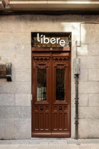 a liger sign above a wooden door on a building at Líbere Bilbao Ledesma in Bilbao