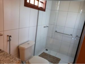 a small bathroom with a toilet and a shower at Estalagem do Carmo in Pirenópolis +11 photos