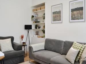 a living room with a couch and a chair at Main Street Flat C-uk46563 in Prestwick