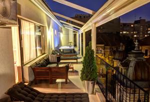 a balcony with a couch and a table on a building at Villa Boutique Lafayette in Bucharest