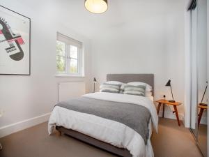 1 dormitorio blanco con 1 cama grande y 2 almohadas en Myrtle House, en Pendeen