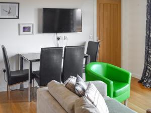 a living room with a couch and chairs and a table at The Lodge - Uk46636 in Culbokie