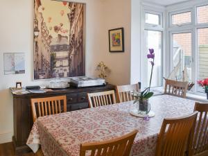 a dining room table and chairs with a table and a table and a table at Avondale in Clacton-on-Sea