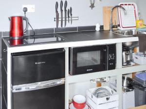 a kitchen with two microwaves and a sink at The Shepherds Hut - Uk46633 in Culbokie