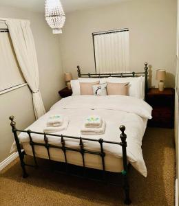 ein Schlafzimmer mit einem Bett mit zwei Handtüchern darauf in der Unterkunft 8 PEMBERTON Entire 3 bed in Newry Mourne and Down Sleeps 5 in Downpatrick