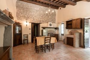 a kitchen with a table and chairs in a room at Birrificio del Catria in Cantiano