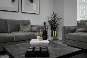 a living room with a couch and a coffee table at The 1878 by STAMP SA in Blackpool +26 photos