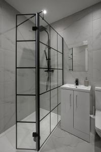 a bathroom with a glass shower and a sink at The 1878 by STAMP SA in Blackpool