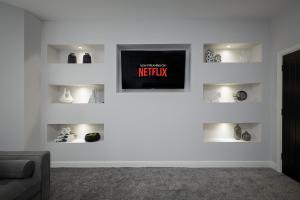 a living room with a tv on a white wall at The 1878 by STAMP SA in Blackpool