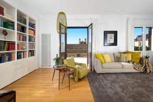 a living room with a couch and a chair at Penthouse Duomo in Catania