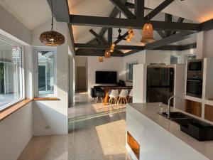 una cucina e un soggiorno con un tavolo di UMiiMAAN pool villa, 4BR, 4BA a Ko Samui