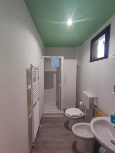 a bathroom with two toilets and a shower and a sink at Borgo degli Ulivi in Crespellano