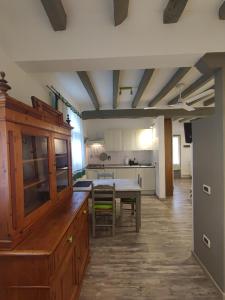 a kitchen with a table and a dining room at Borgo degli Ulivi in Crespellano