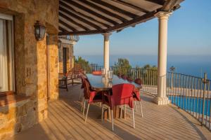 a patio with a table and chairs on a balcony at COSTA BRAVA SUITES Villa Bonavida in Sant Feliu de Guixols