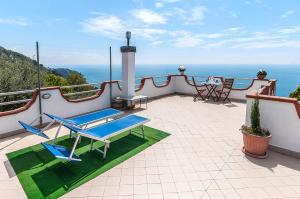 a balcony with two blue chairs and a table at A Casa Di Eta in Gaeta