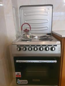 a stove with a tea kettle on top of it at BEST7 two bedroom apt in UN Kazanchis area in Addis Ababa