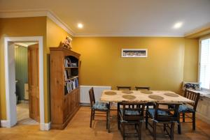 a dining room with a table and chairs at The House on the Square- Coastal Townhouse in Saint Monance
