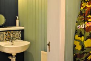 a bathroom with a sink and a mirror and a sink at The House on the Square- Coastal Townhouse in Saint Monance