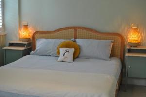 a bed with a pillow on it with two lamps at The House on the Square- Coastal Townhouse in Saint Monance