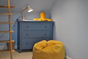a blue dresser with a rubber duck sitting on top of it at The House on the Square- Coastal Townhouse in Saint Monance