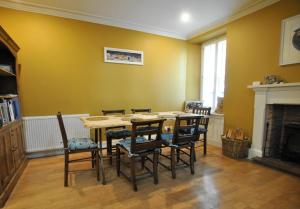 a dining room with a table and chairs at The House on the Square- Coastal Townhouse in Saint Monance