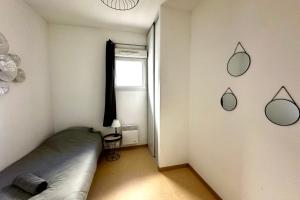 a bedroom with a bed and mirrors on the wall at Les Naïades D15- 2 bedrooms for 5 people ! in Avène