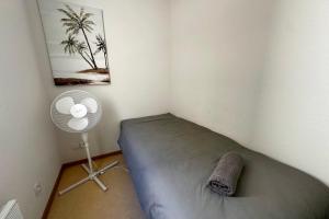 a bedroom with a bed with a fan at Les Naïades E20 - 2 bedrooms for 5 people ! in Avène