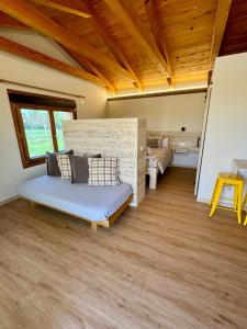 a living room with a couch and a wooden floor at Alojamientos La Alberca in Arguedas