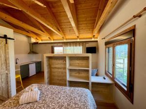 a bedroom with a bed in a room with wooden ceilings at Alojamientos La Alberca in Arguedas