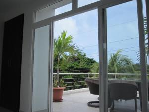 a sliding glass door with a view of a balcony at Lili House in San Andrés