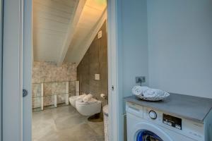 un baño con inodoro y lavabo en Loft & Jacuzzi - Happy Rentals, en Riva del Garda