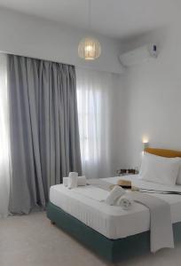 En eller flere senge i et værelse på Kipos Livinn