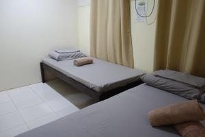 Кровать или кровати в номере Mi Casa Suites Siargao